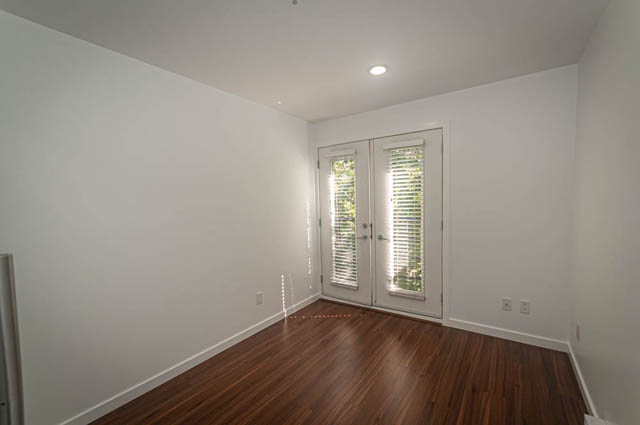 Bright living room with hardwood floors and large windows. - 2753 Guelph Street, Vancouver East Side