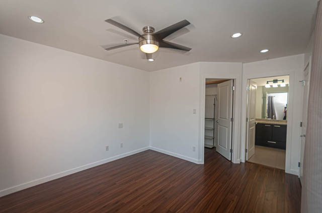 Bright living room with hardwood floors and modern ceiling fan. - 2753 Guelph Street, Vancouver East Side