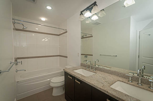 Bright bathroom with granite countertops and modern lighting fixtures. - 2753 Guelph Street, Vancouver East Side