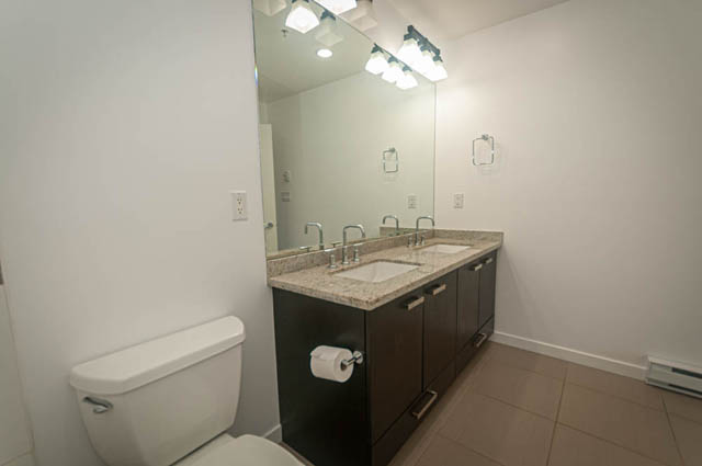Bathroom with granite countertops and modern lighting fixtures. - 2753 Guelph Street, Vancouver East Side