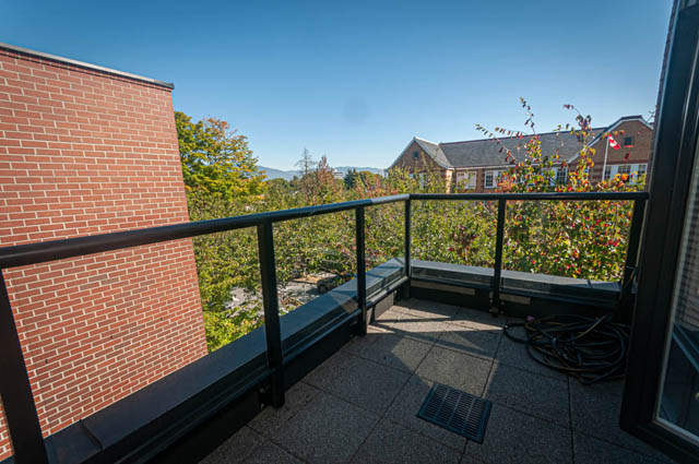 Furnished balcony with brick wall and city view. - 2753 Guelph Street, Vancouver East Side