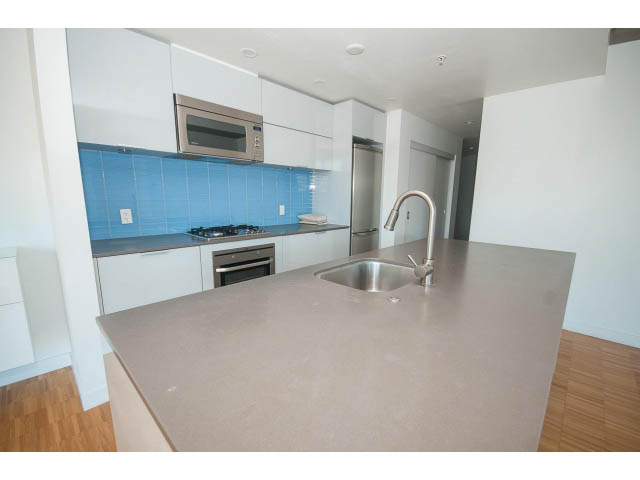 Bright kitchen with modern countertops and hardwood floors. - 803 - 128 Cordova St W, Vancouver Downtown