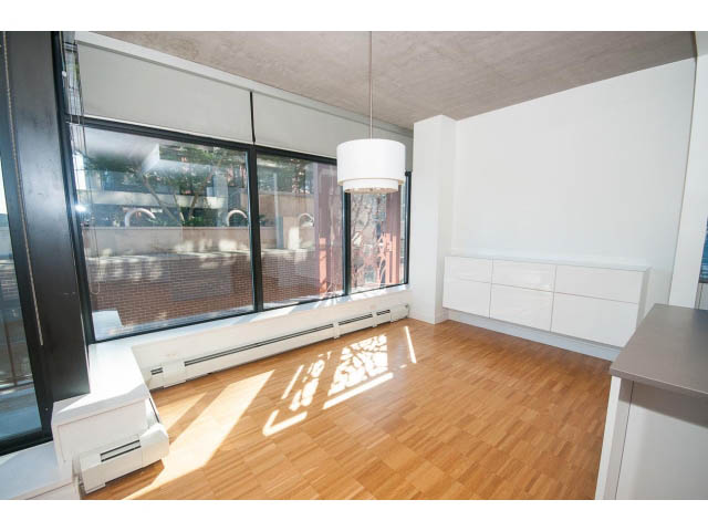 Bright kitchen with white cabinets, hardwood floors, and a city view. - 803 - 128 Cordova St W, Vancouver Downtown