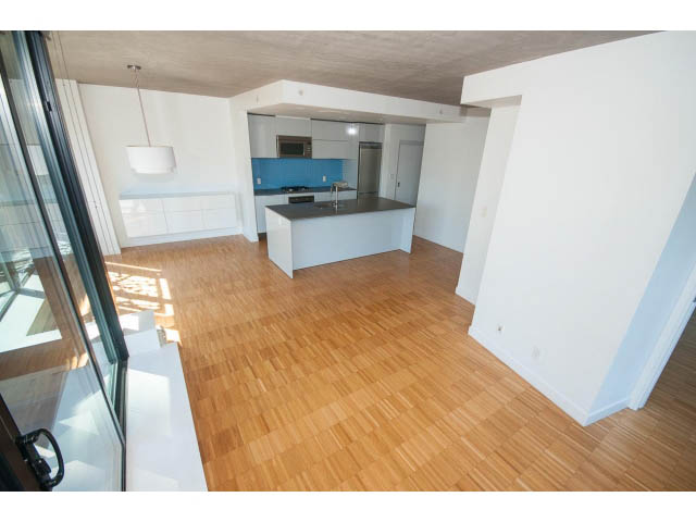 Bright kitchen with modern island, hardwood floors, and city view. - 803 - 128 Cordova St W, Vancouver Downtown