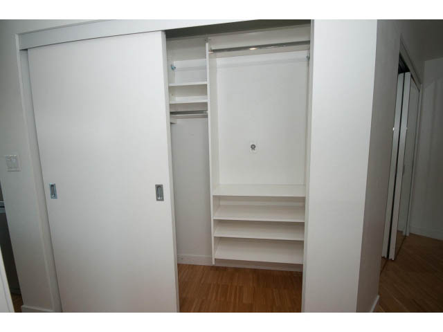 Bright walk-in closet with sliding doors and built-in shelves. - 803 - 128 Cordova St W, Vancouver Downtown