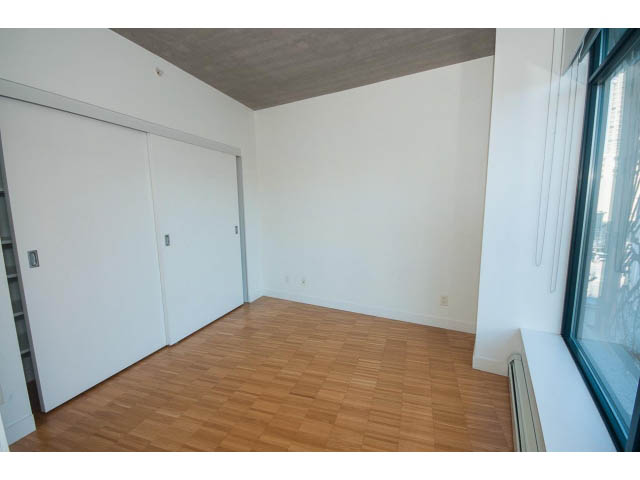 Bright living room with hardwood floors and large windows offering city views. - 803 - 128 Cordova St W, Vancouver Downtown