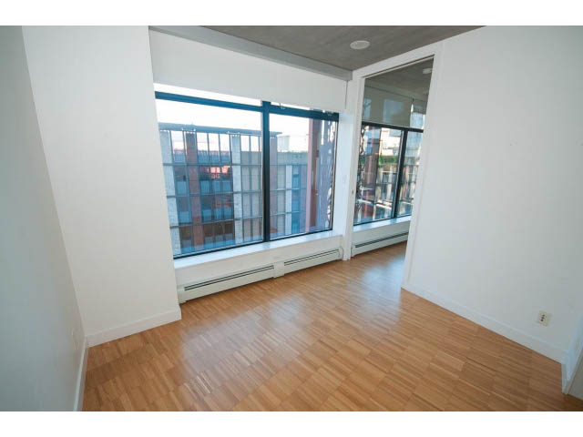 Spacious living room with hardwood floors and city view. - 803 - 128 Cordova St W, Vancouver Downtown