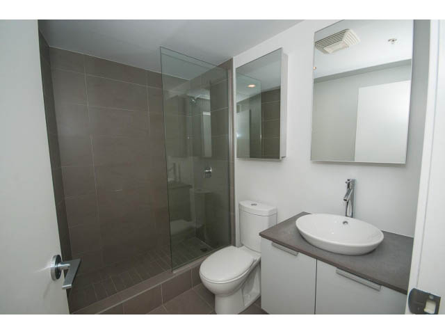 Furnished bathroom with modern sink, toilet, and glass shower. - 803 - 128 Cordova St W, Vancouver Downtown