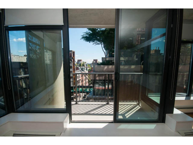 Bright living room with large windows and city view. - 803 - 128 Cordova St W, Vancouver Downtown