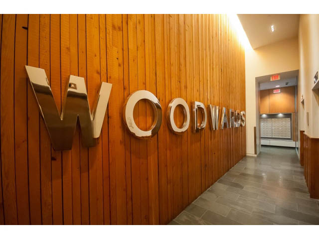 Foyer with wooden wall and metallic "Woodwards" sign. - 803 - 128 Cordova St W, Vancouver Downtown