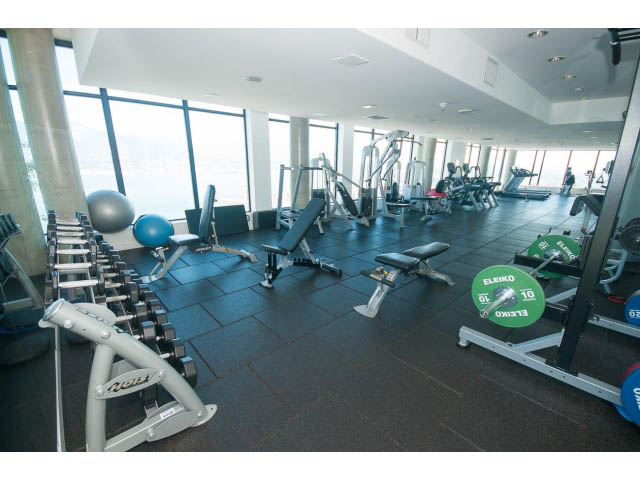 Spacious gym with large windows, city view, and various exercise equipment. - 803 - 128 Cordova St W, Vancouver Downtown