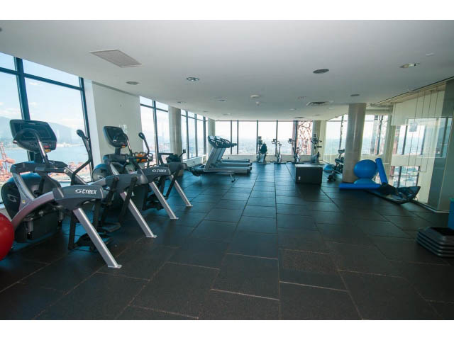 Spacious gym with large windows, city view, and modern equipment. - 803 - 128 Cordova St W, Vancouver Downtown