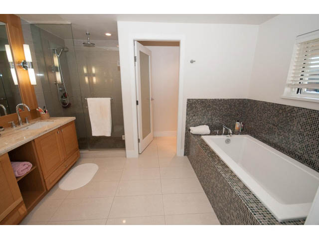 Spacious bathroom with granite countertops and mosaic tile accents. - 26 - 555 Raven Woods Drive, North Vancouver
