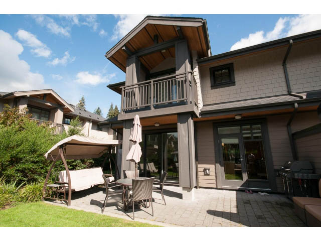 Furnished patio with outdoor seating and a covered awning. - 26 - 555 Raven Woods Drive, North Vancouver