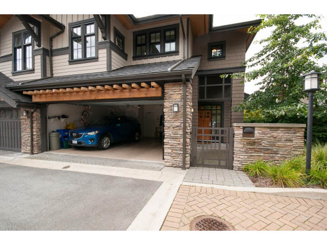 Furnished 4-bedroom townhouse with a spacious garage and stone accents. - 26 - 555 Raven Woods Drive, North Vancouver