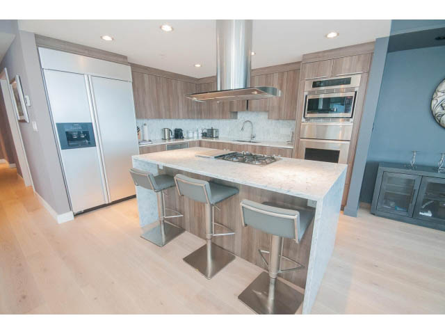Bright kitchen with light wood cabinets, stainless steel appliances, and a marble island. - 1702 - 1281 W. Cordova Street, Vancouver Downtown