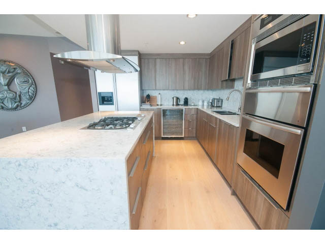 Bright kitchen with marble countertops, hardwood floors, and stainless steel appliances. - 1702 - 1281 W. Cordova Street, Vancouver Downtown