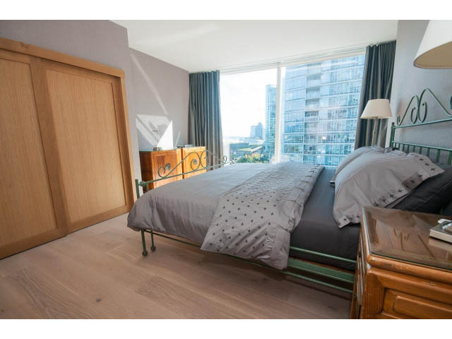 Bright bedroom with hardwood floors and a city view, furnished with a bed and dresser. - 1702 - 1281 W. Cordova Street, Vancouver Downtown