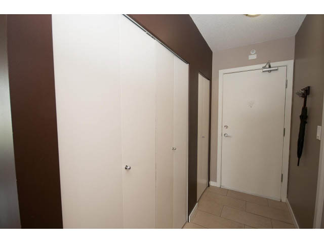 Furnished hallway with sliding closet doors and tiled floor. - 1202 - 480 Robson Street, Vancouver Downtown