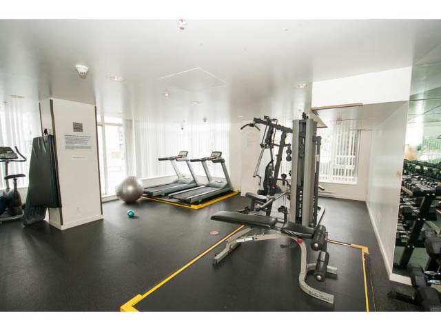 Bright gym with cardio machines, weights, and mirrors. - 1202 - 480 Robson Street, Vancouver Downtown