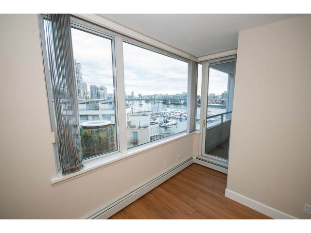 Bright living room with hardwood floors and a stunning city view. - 707 - 1288 Marinaside Crescent, Vancouver Downtown