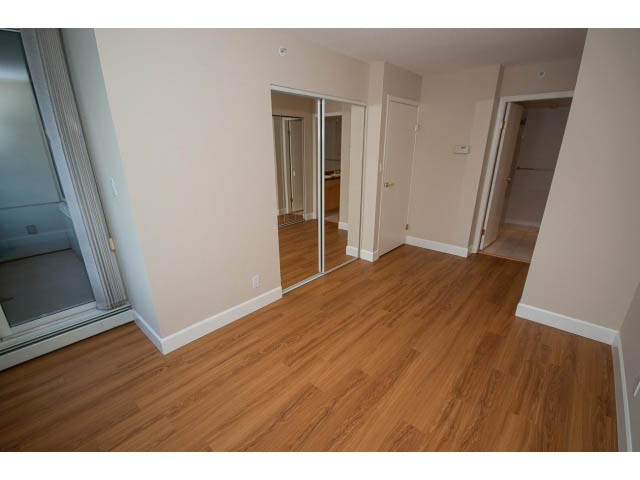Bright living room with hardwood floors and sliding glass door leading to balcony. - 707 - 1288 Marinaside Crescent, Vancouver Downtown