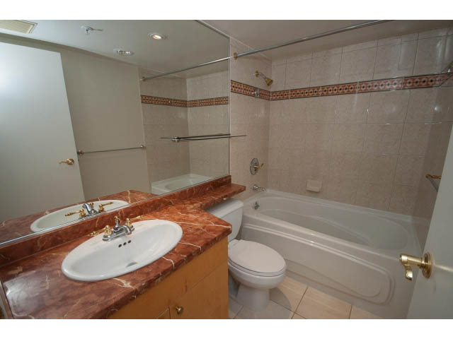 Furnished bathroom with marble countertops and a bathtub. - 707 - 1288 Marinaside Crescent, Vancouver Downtown