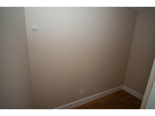Empty living room with neutral walls and hardwood floors. - 707 - 1288 Marinaside Crescent, Vancouver Downtown