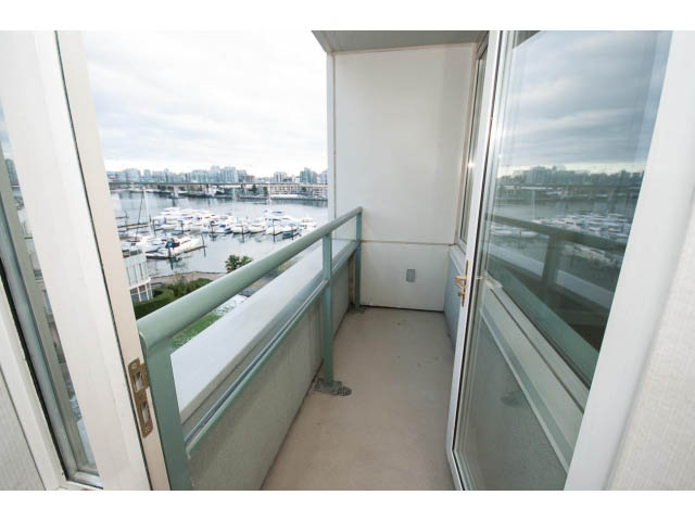 Furnished balcony with city view and glass railings. - 707 - 1288 Marinaside Crescent, Vancouver Downtown