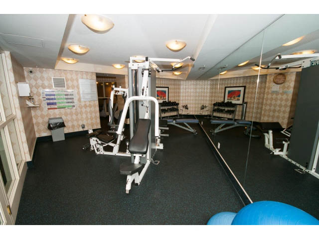 Furnished fitness room with exercise equipment and mirrors. - 707 - 1288 Marinaside Crescent, Vancouver Downtown