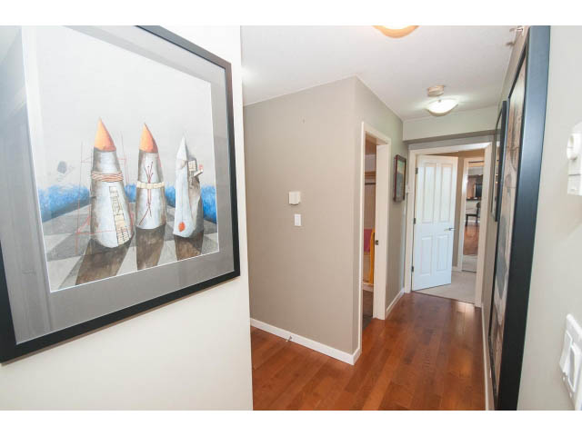 Bright hallway with hardwood floors and modern art on the wall. - 603 - 1425 West 6th Ave, Vancouver West Side