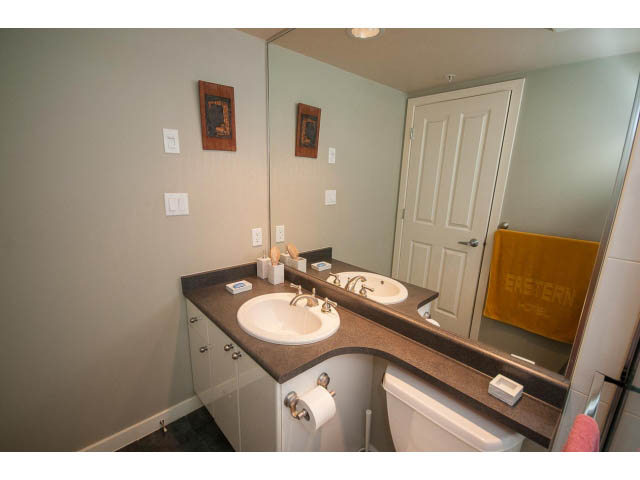 Furnished bathroom with granite countertops and a large mirror. - 603 - 1425 West 6th Ave, Vancouver West Side
