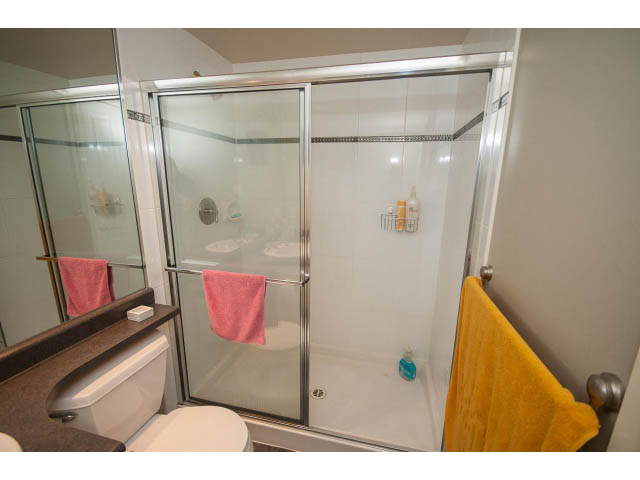 Furnished bathroom with sliding glass shower and pink towels. - 603 - 1425 West 6th Ave, Vancouver West Side
