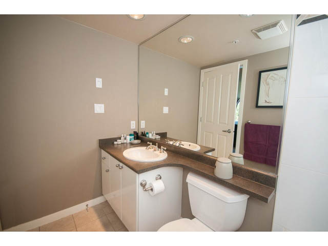 Furnished bathroom with granite countertops and a large mirror. - 603 - 1425 West 6th Ave, Vancouver West Side