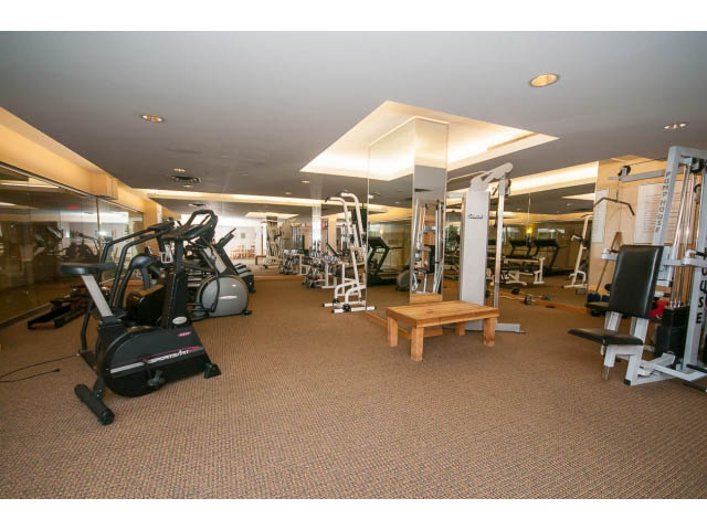 Spacious, well-lit gym with cardio machines and mirrors. - 603 - 1425 West 6th Ave, Vancouver West Side