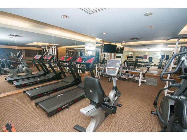 Furnished gym with treadmills, ellipticals, and mirrors. - 603 - 1425 West 6th Ave, Vancouver West Side