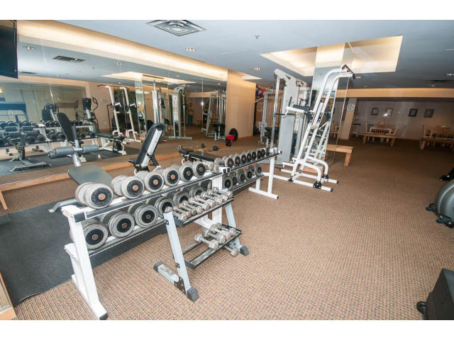 Furnished gym with weight machines and mirrors. - 603 - 1425 West 6th Ave, Vancouver West Side