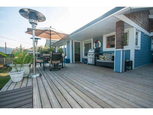 Furnished patio with wooden deck, outdoor furniture, and a propane heater. - 389 Beachview Dr, North Vancouver