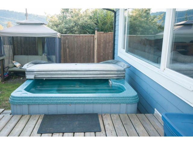 Spacious deck with hot tub and wooden deck flooring. - 389 Beachview Dr, North Vancouver