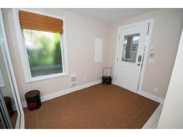 Bright entryway with cork flooring and frosted glass window. - 389 Beachview Dr, North Vancouver