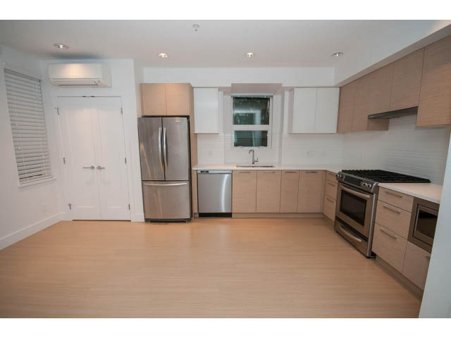 Bright kitchen with light wood cabinets, stainless steel appliances, and hardwood floors. - 9 - 3508 Mount Seymour Pkwy, North Vancouver