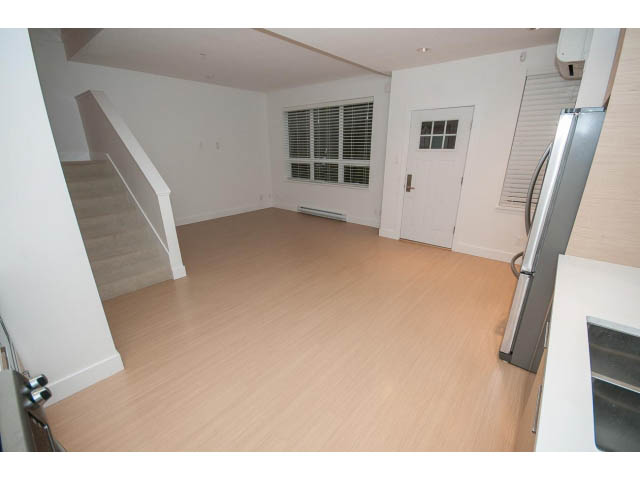 Bright kitchen with stainless steel appliances and hardwood floors. - 9 - 3508 Mount Seymour Pkwy, North Vancouver