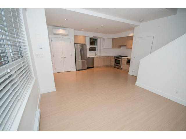 Bright kitchen with stainless steel appliances and light wood cabinets, hardwood floors throughout. - 9 - 3508 Mount Seymour Pkwy, North Vancouver