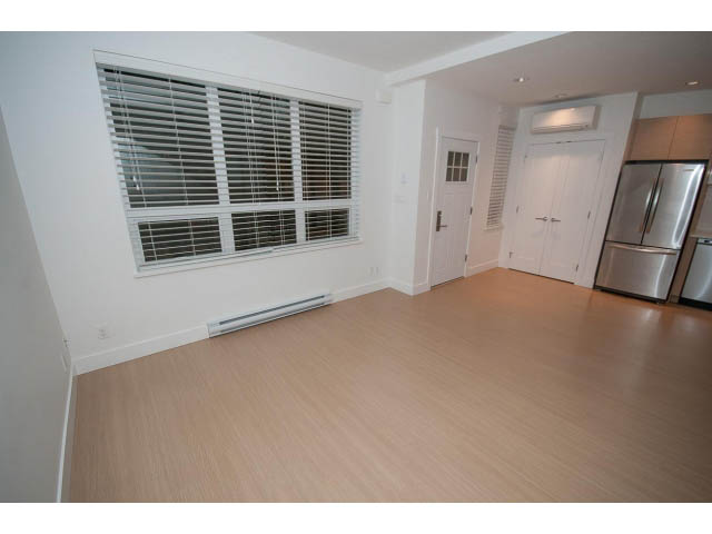 Bright kitchen with hardwood floors and stainless steel appliances. - 9 - 3508 Mount Seymour Pkwy, North Vancouver
