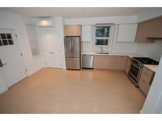 Bright kitchen with light wood cabinets, stainless steel appliances, and hardwood floors. - 9 - 3508 Mount Seymour Pkwy, North Vancouver