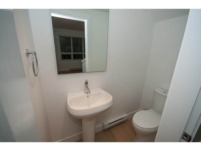 Compact bathroom with white fixtures and a small window view. - 9 - 3508 Mount Seymour Pkwy, North Vancouver