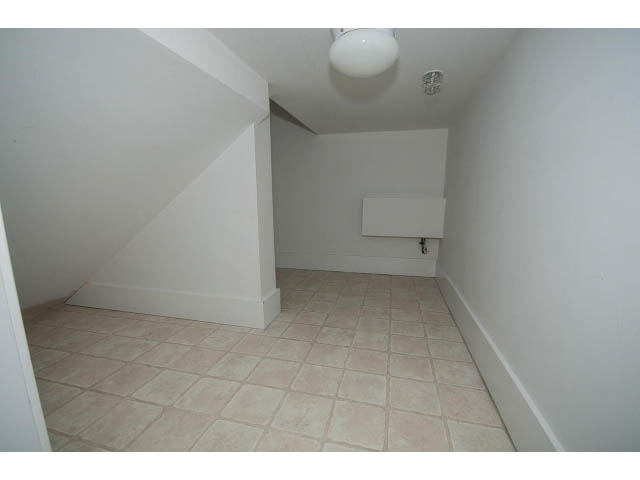 Bright laundry room with tiled floor and white walls. - 9 - 3508 Mount Seymour Pkwy, North Vancouver