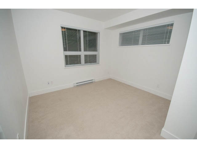 Bright bedroom with carpeted floor and blinds covering windows. - 9 - 3508 Mount Seymour Pkwy, North Vancouver