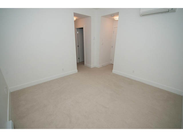 Bright living room with carpeted floor and white walls. - 9 - 3508 Mount Seymour Pkwy, North Vancouver