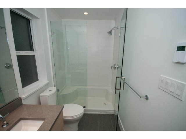 Modern bathroom with glass shower and granite countertop. - 9 - 3508 Mount Seymour Pkwy, North Vancouver